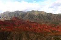 an aerial view of a red colored mountain range